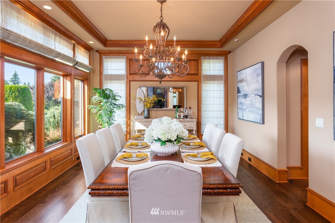 903 Belfair Road Bellevue, WA 98004 - Photo 10 of 36 a view of a dining room with furniture wooden floor and chandelier