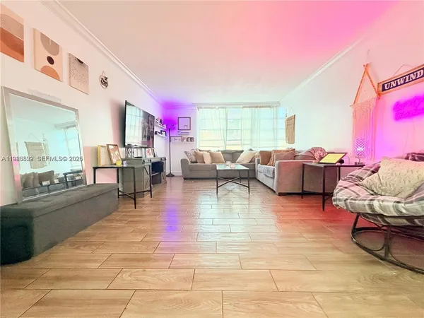 a living room with furniture a rug and a table