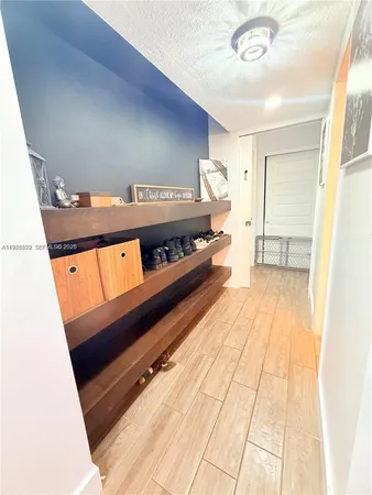 a view of a room with wooden floor