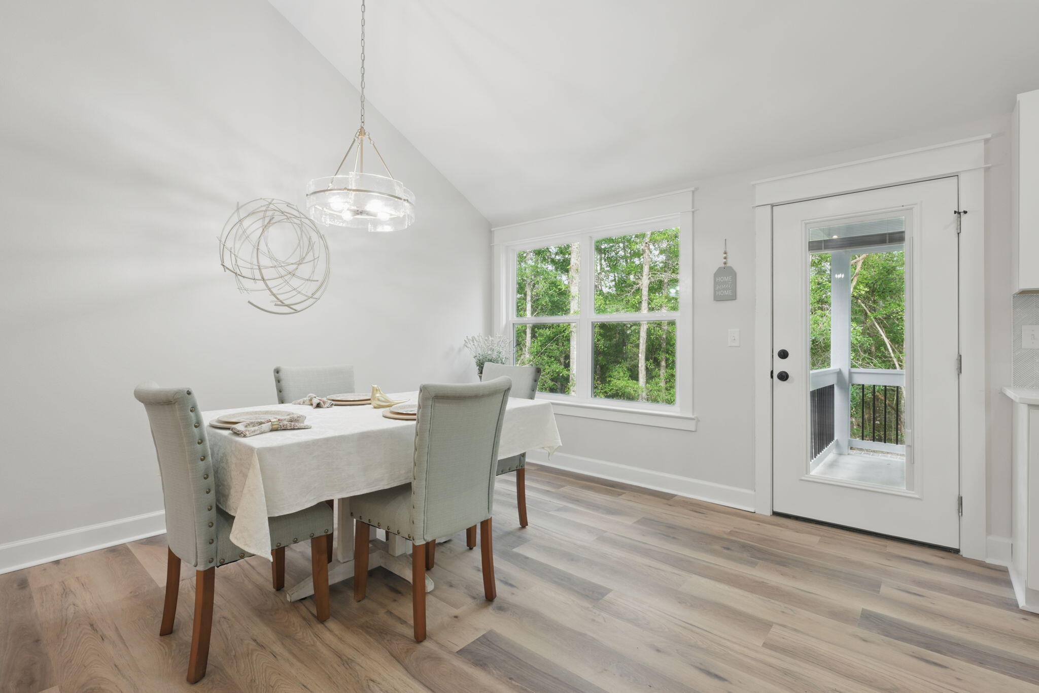 134 Deer Valley Road DeFuniak Springs, FL 32433 - Photo 21 of 82 a dining room with wooden floor a chandelier a wooden table and chairs