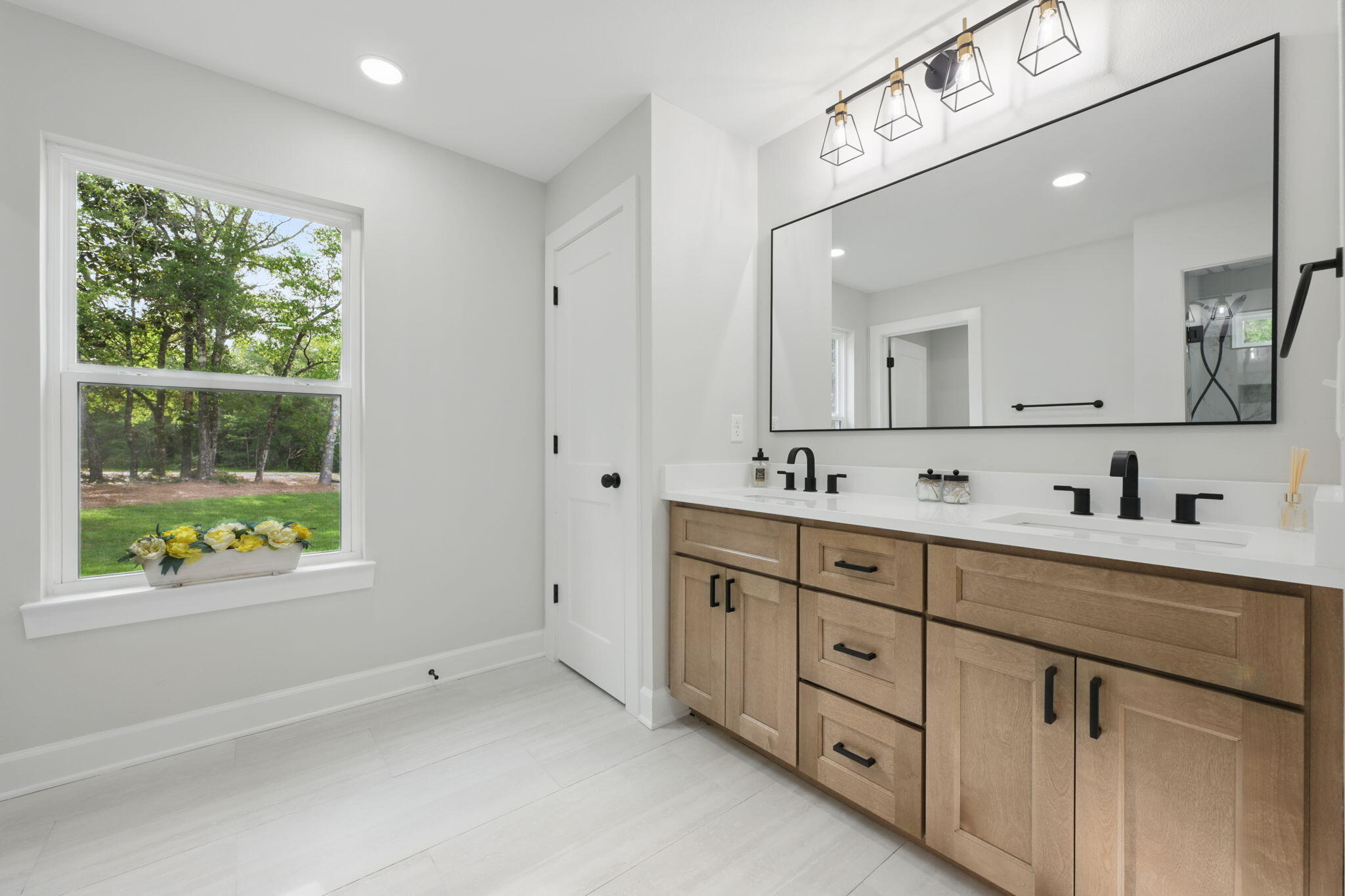 134 Deer Valley Road DeFuniak Springs, FL 32433 - Photo 40 of 82 a spacious bathroom with double vanity sink a mirror a window and a bathtub
