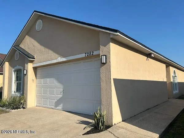 a view of a door and wooden floor