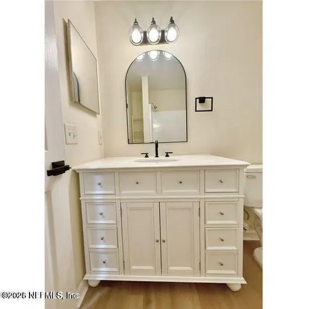 a bathroom with a double vanity sink and a mirror