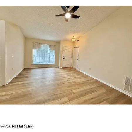 a view interior of a house a ceiling fan and wooden floor