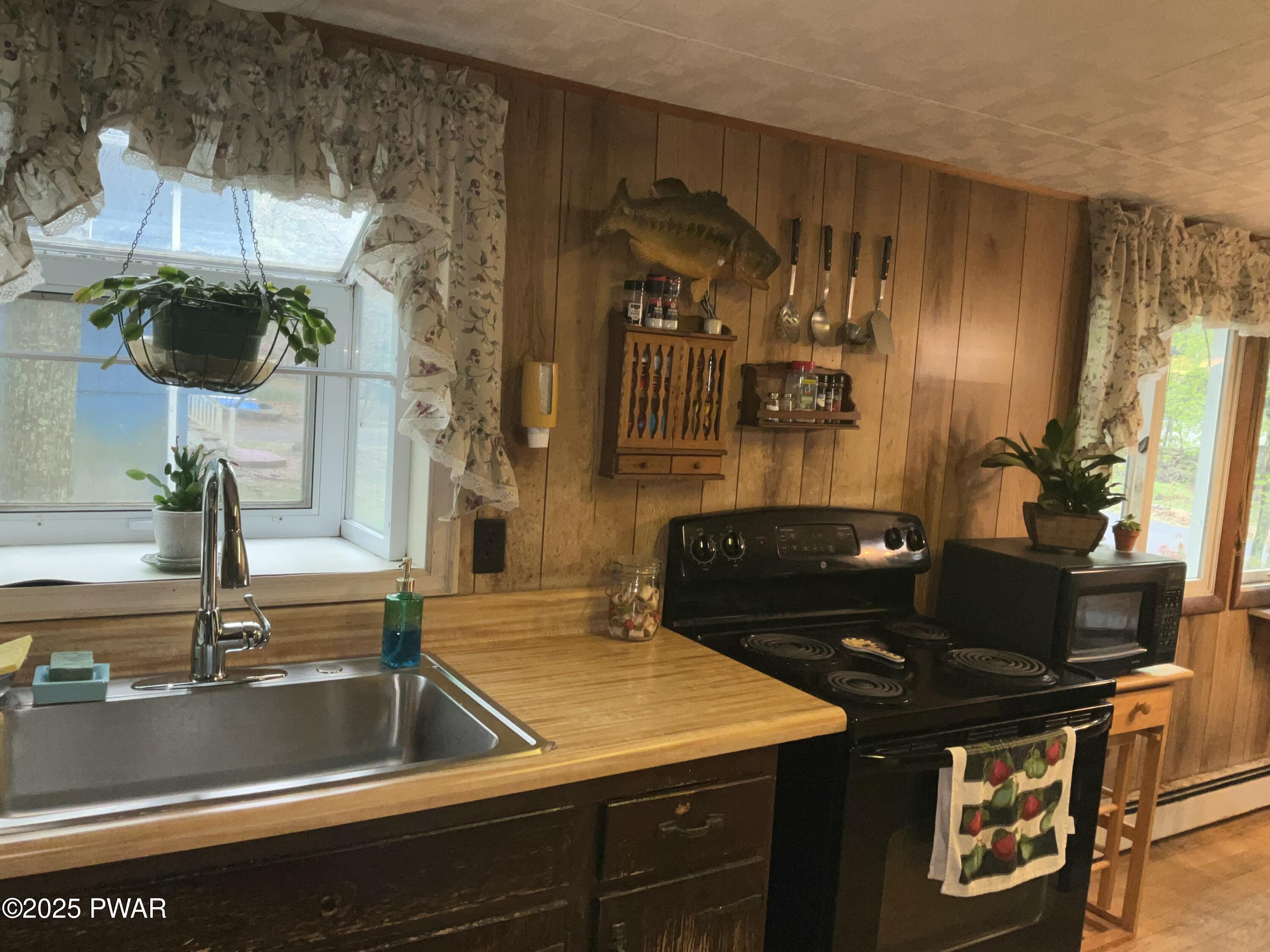 124 Roundhill Road Dingmans Ferry, PA 18328 - Photo 16 of 47 a kitchen with a stove and a sink