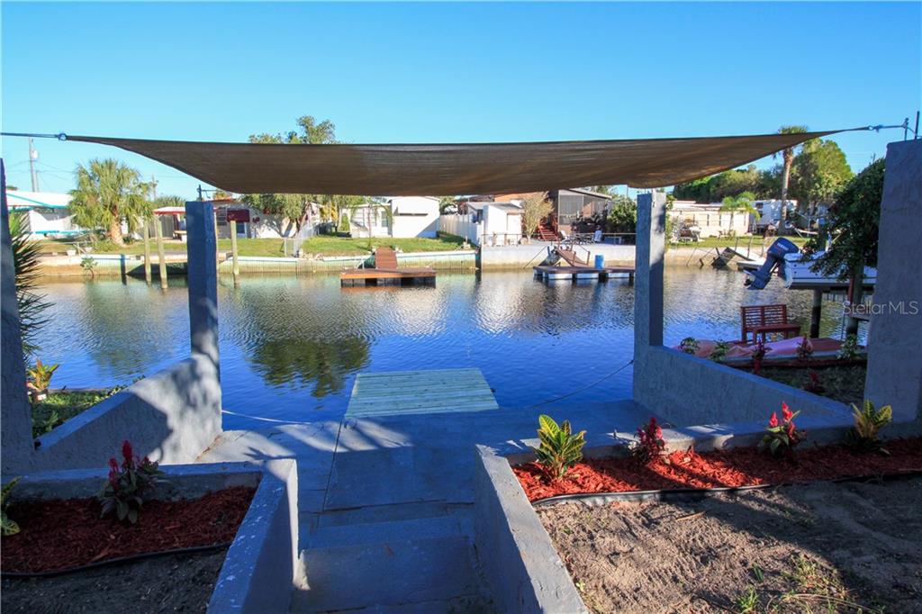 Backyard view with great concrete area for entertaining.  Imagine relaxing in your outdoor seating while grilling some freshly caught fish that you cleaned at your fish cleaning station.  So many possibilities here for you to enjoy the salt life!