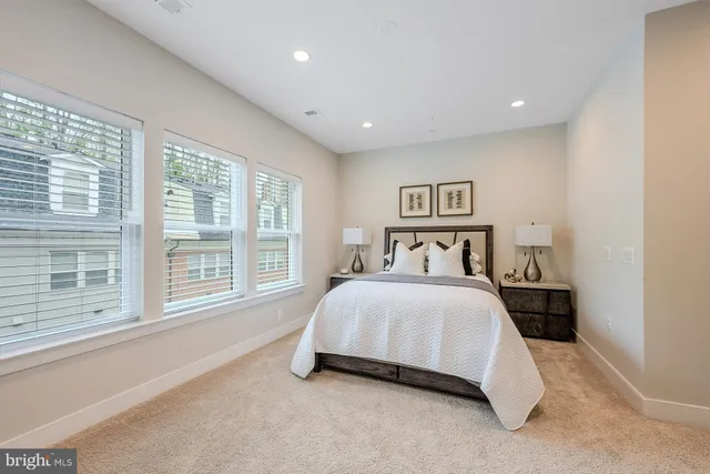 a bedroom with a large bed and a large window