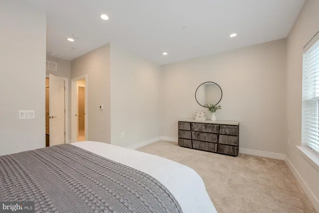 a bedroom with bed and window