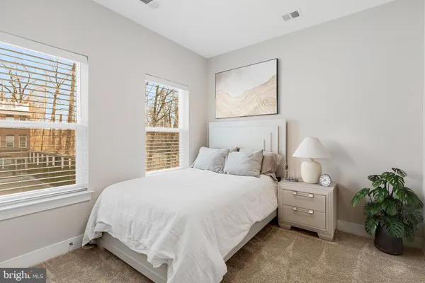 a bed room with a bed and a potted plant