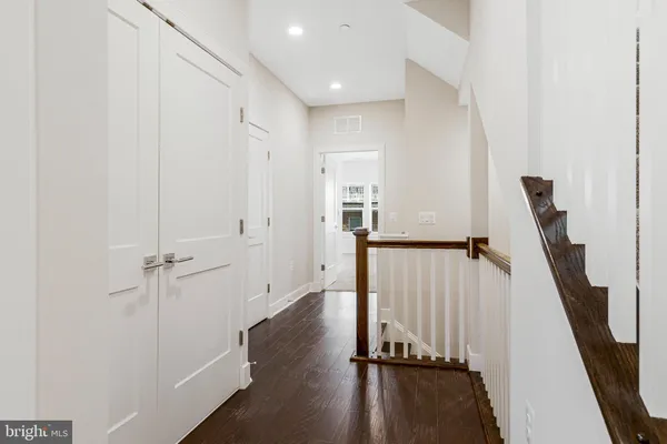 a view of a hallway with a white door and staircase