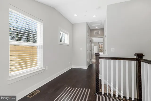 a bathroom with a toilet a sink a mirror a bathtub and vanity