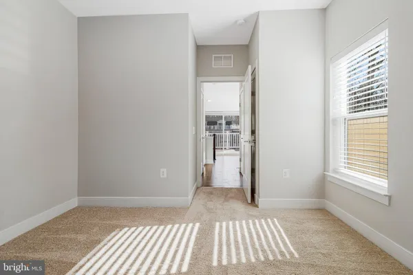 a work room with wooden floor and white walls