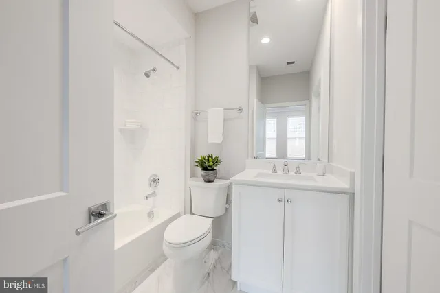 a view of hallway with stairs and wooden floor