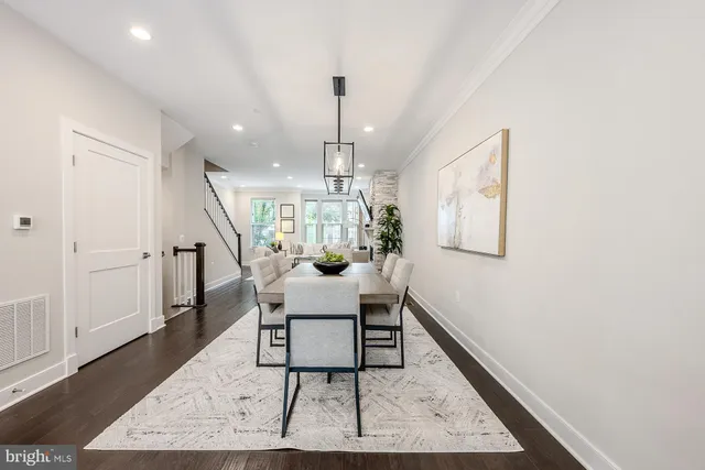 a dining room with furniture a rug and wooden floor