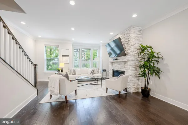 a living room with furniture wooden floor and a flat screen tv