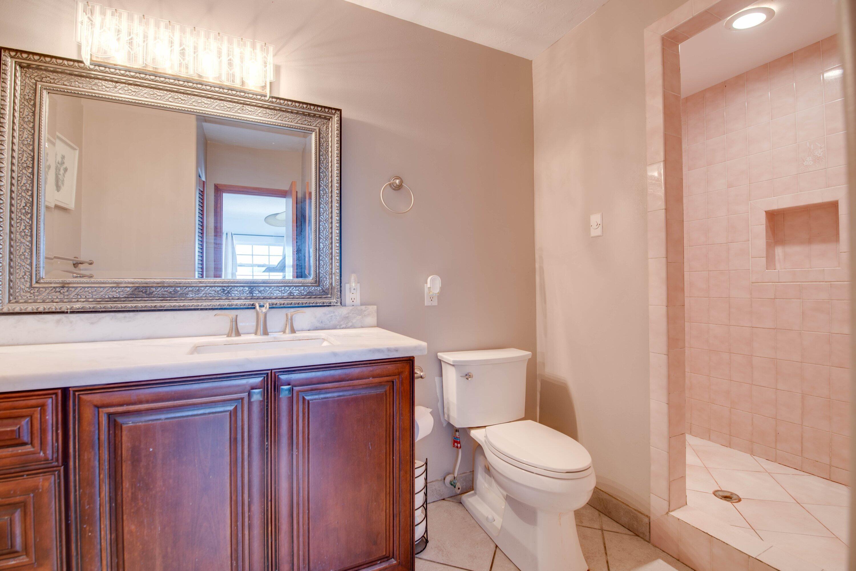 27821 Leeward S Road Summerland Key, FL 33042 - Photo 15 of 32 a bathroom with a toilet a sink and mirror