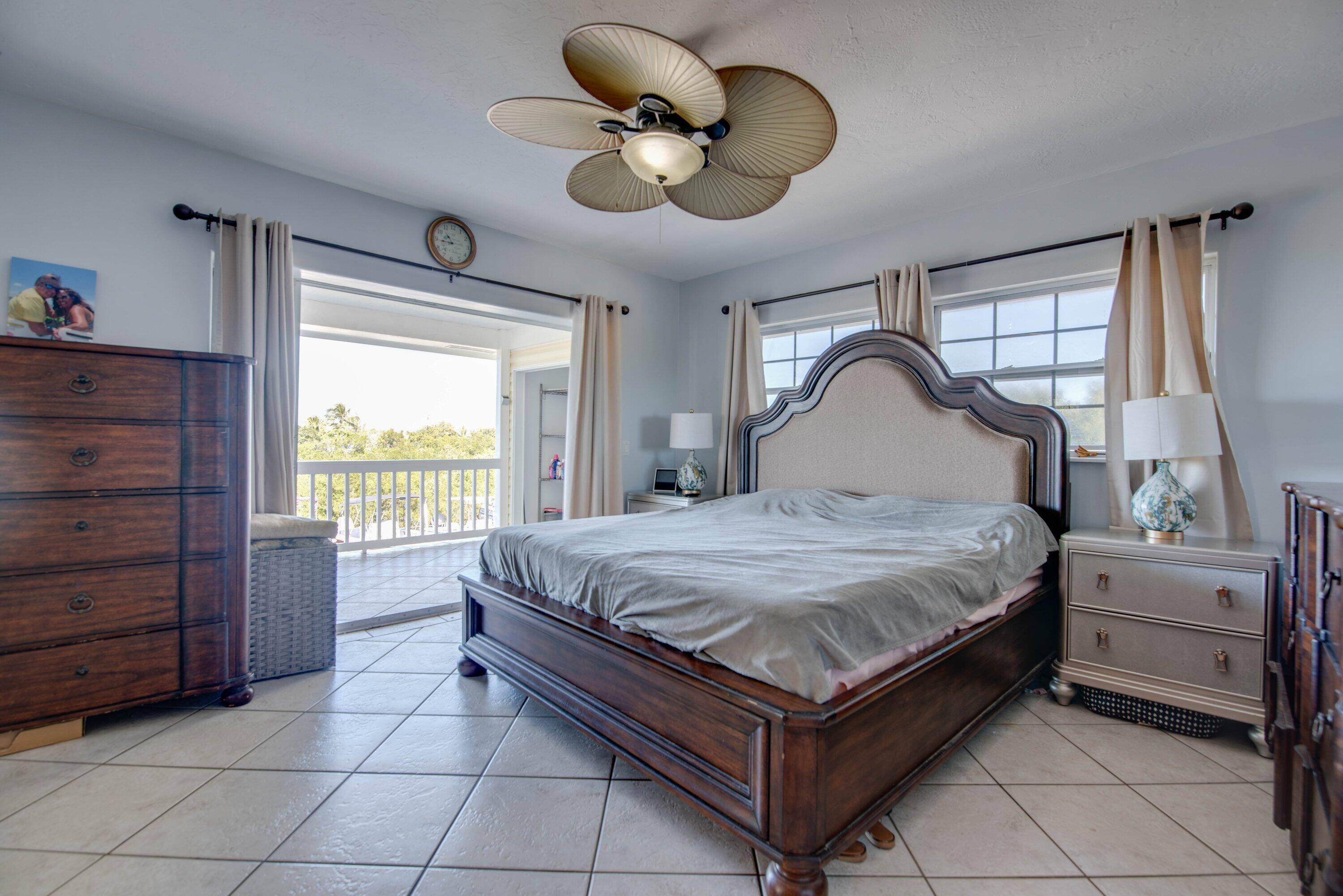 27821 Leeward S Road Summerland Key, FL 33042 - Photo 16 of 32 a bedroom with a bed and a dresser