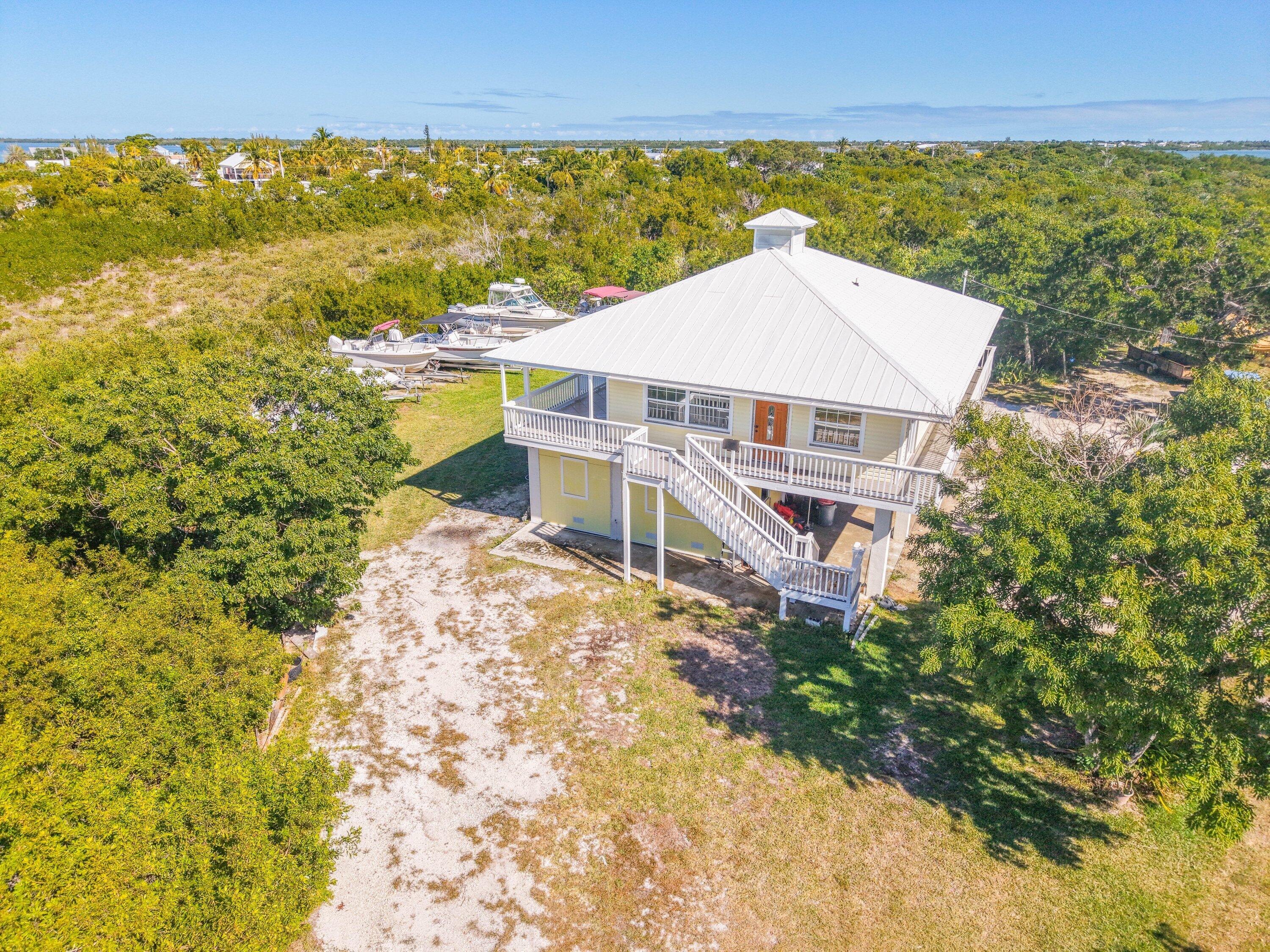 27821 Leeward S Road Summerland Key, FL 33042 - Photo 3 of 32 a view of a terrace with a garden