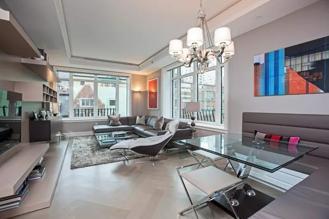 a living room with furniture fireplace and a large window