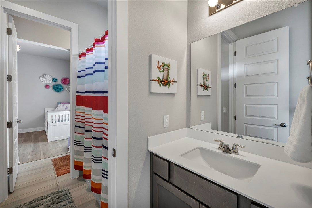 7808 Chrysler Bend Austin, TX 78744 - Photo 25 of 35 Jack and Jill bath adjoins 2nd and 3rd bedroom on main floor.