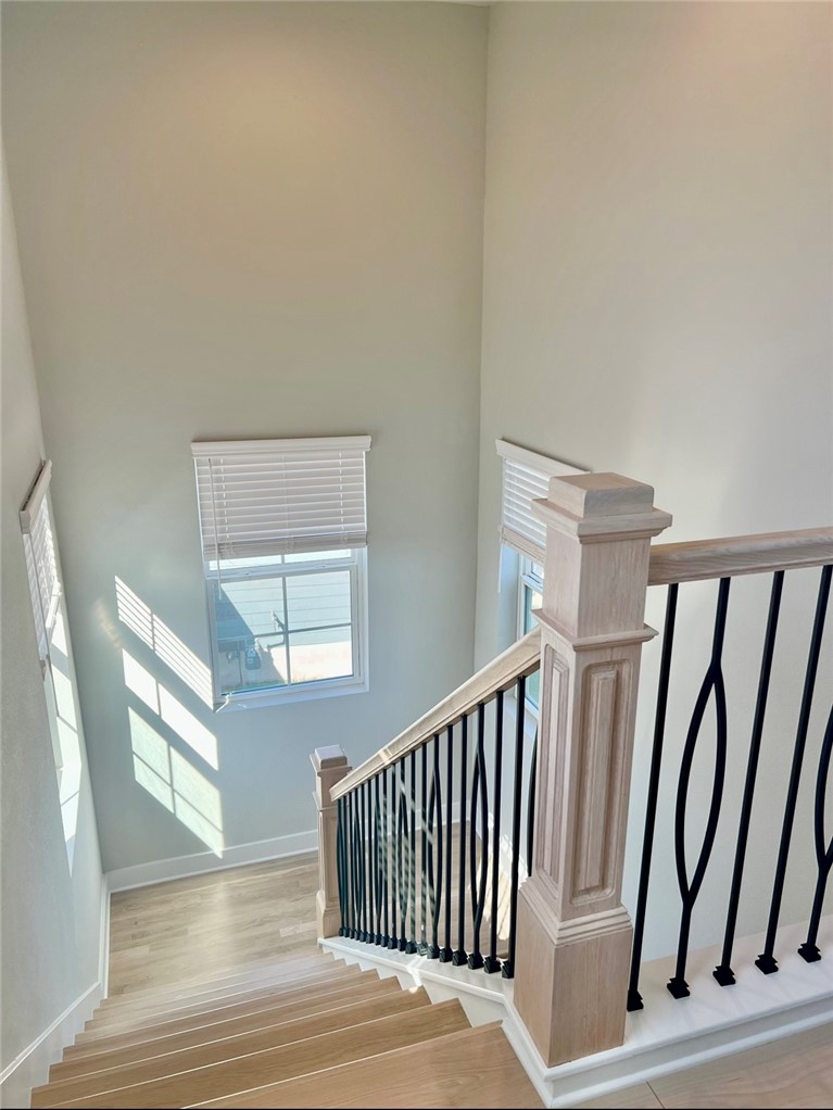 7808 Chrysler Bend Austin, TX 78744 - Photo 28 of 35 The staircase and landing is flooded with light with wood finishes and a modern railing leads. It leads to the upstairs 4th guest bedroom with en-suite bath.