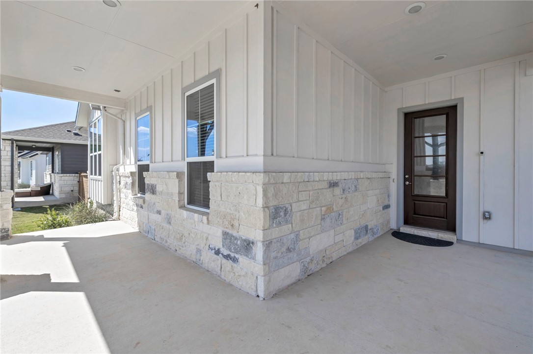 7808 Chrysler Bend Austin, TX 78744 - Photo 3 of 35 Enjoy watching beautiful sunsets on this spacious wraparound porch with plenty of room for swings and seating.