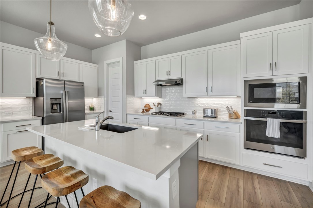 7808 Chrysler Bend Austin, TX 78744 - Photo 4 of 35 This light and bright kitchen has a large center island with quartz countertops