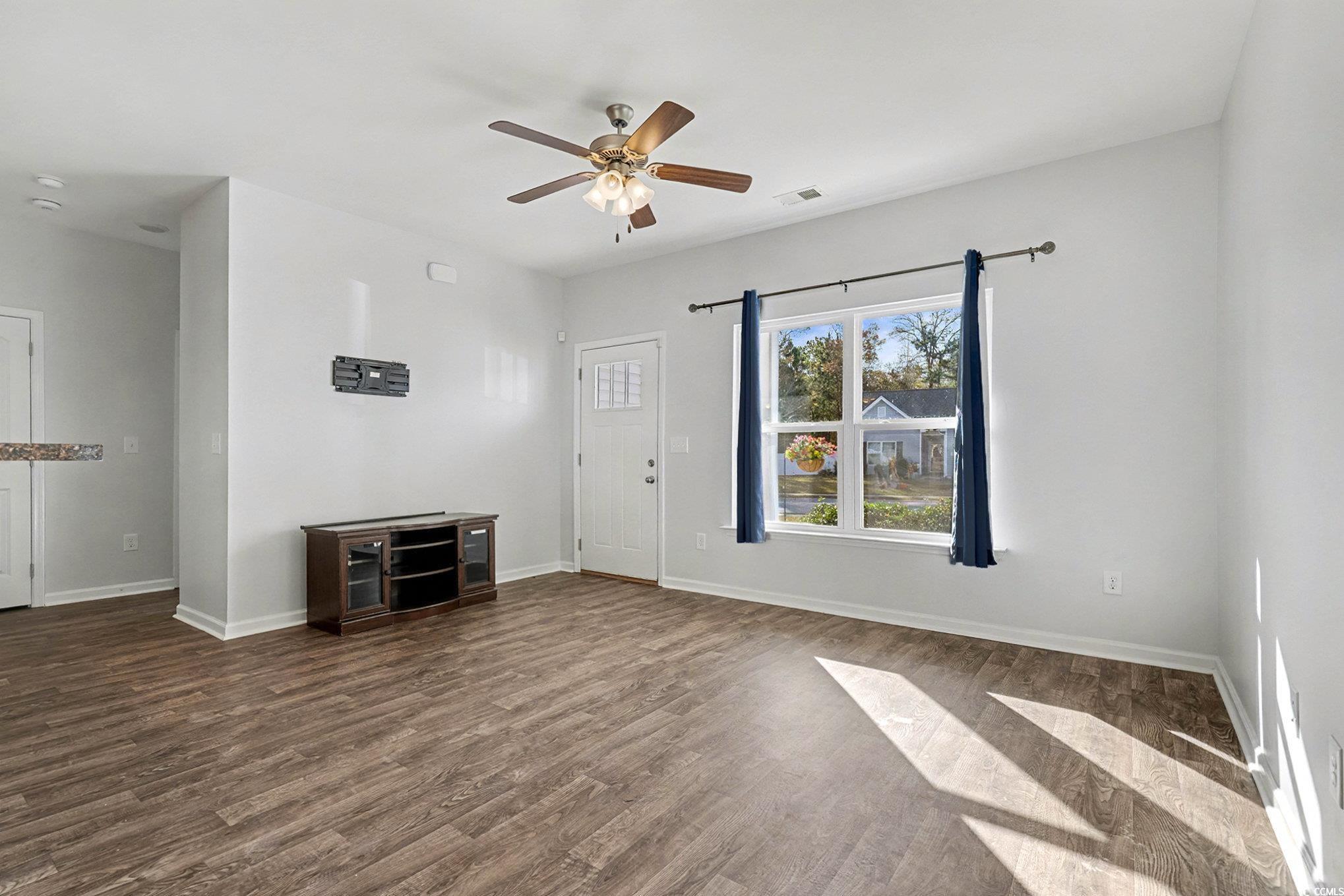 197 Springtide Drive Conway, SC 29527 - Photo 2 of 21 Unfurnished living room featuring dark wood-style flooring and a ceiling fan
