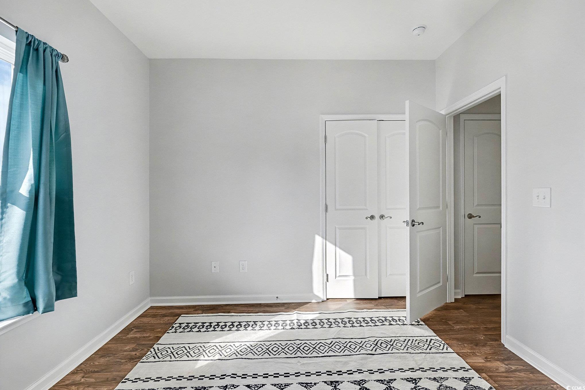 197 Springtide Drive Conway, SC 29527 - Photo 9 of 21 Empty room featuring dark wood-style flooring