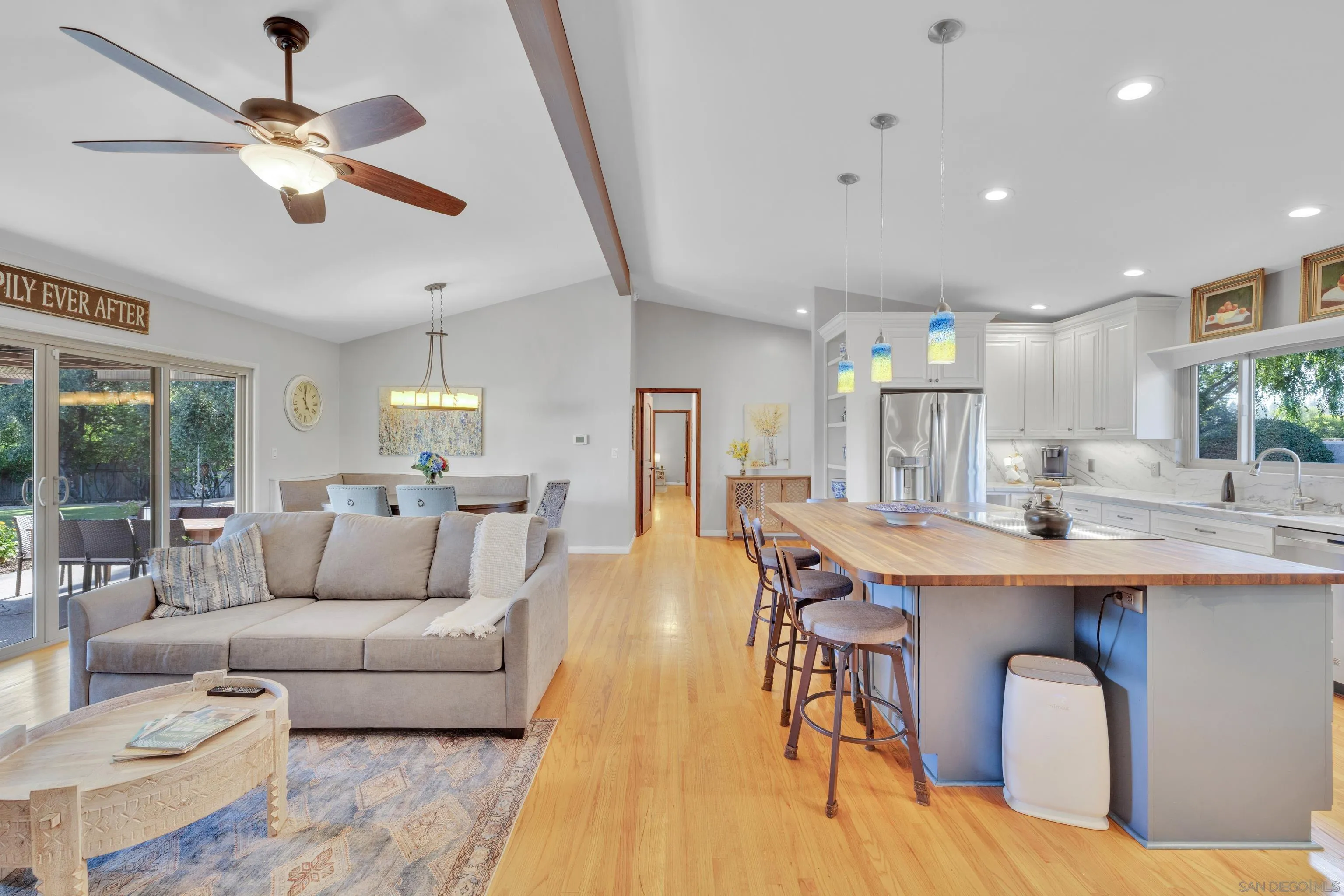 16548 Espola Road Poway, CA 92064 - Photo 23 of 70 a living room with stainless steel appliances kitchen island granite countertop furniture a rug kitchen view and a chandelier