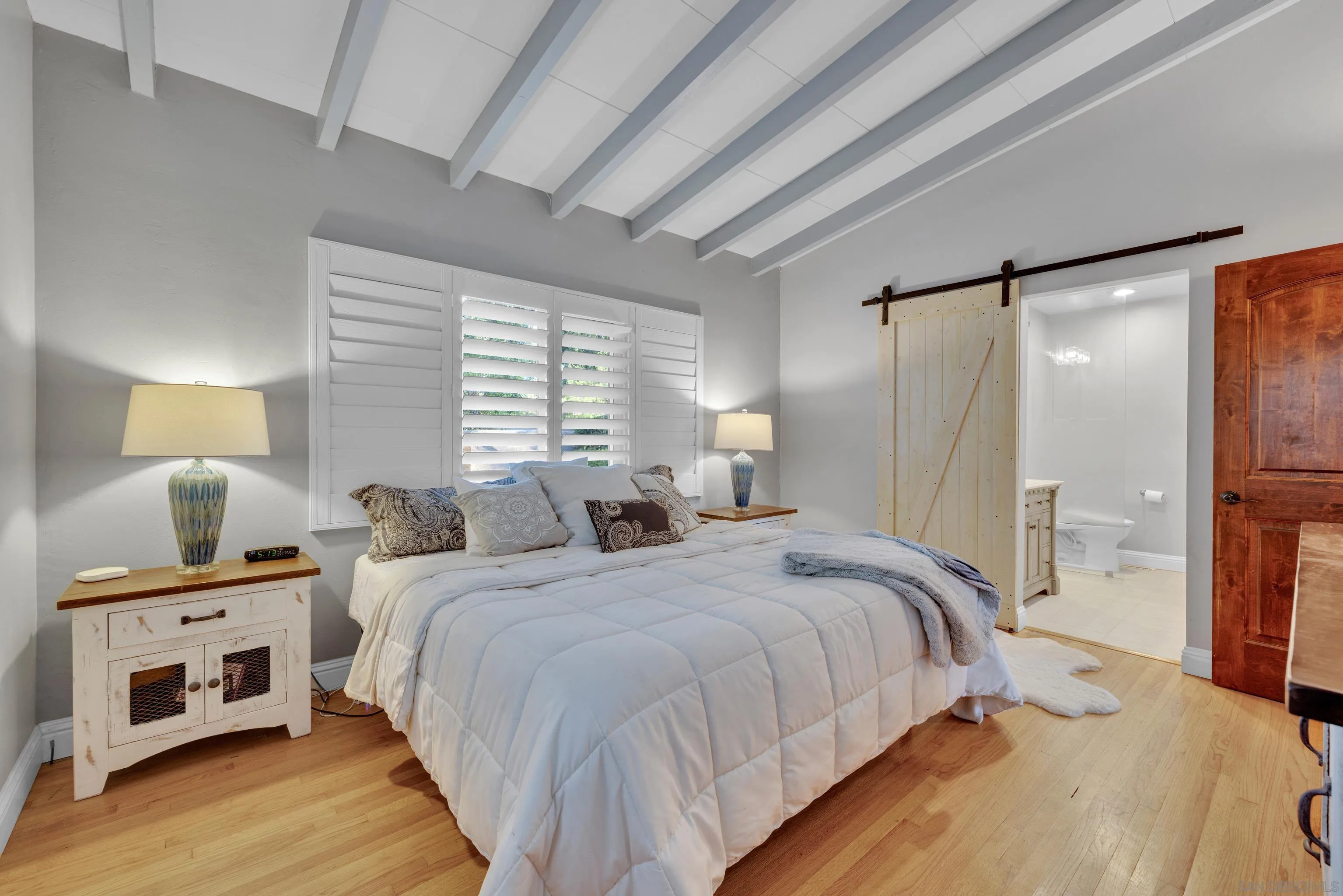 16548 Espola Road Poway, CA 92064 - Photo 31 of 70 a bedroom with a bed and a night stand