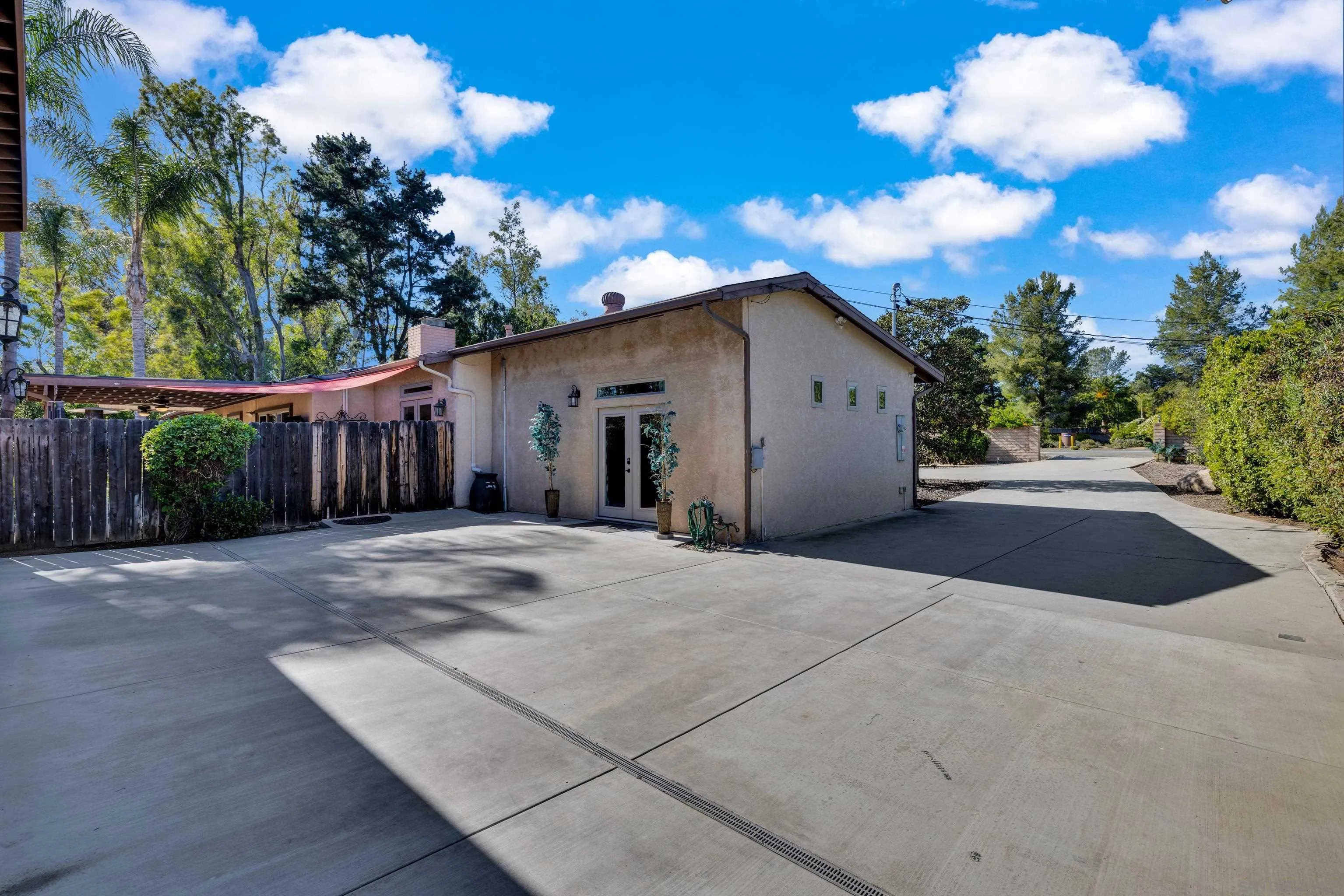 16548 Espola Road Poway, CA 92064 - Photo 43 of 70 a view of a white house with a yard and parking space