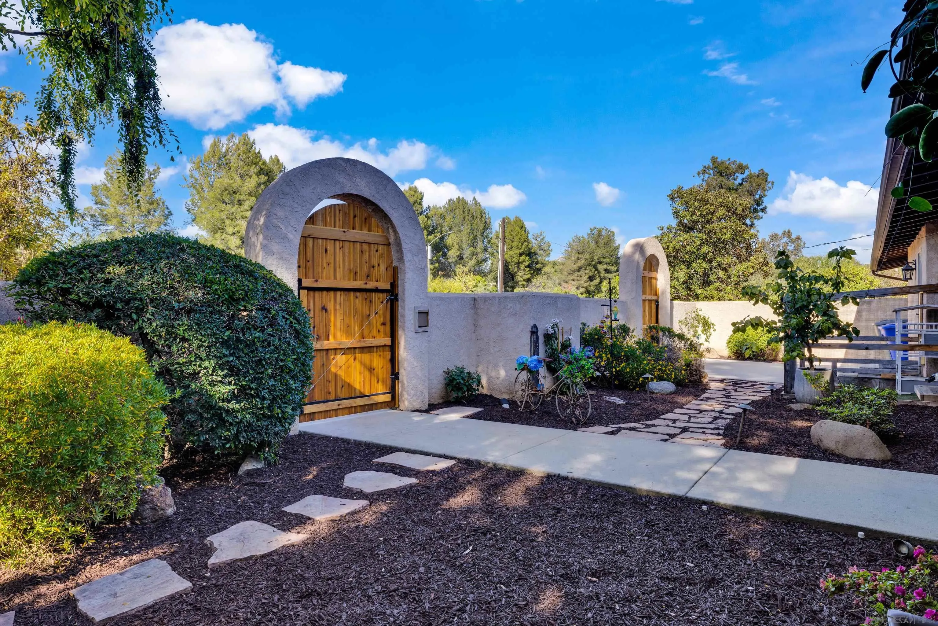 16548 Espola Road Poway, CA 92064 - Photo 5 of 70 a front view of a house with a yard and garage