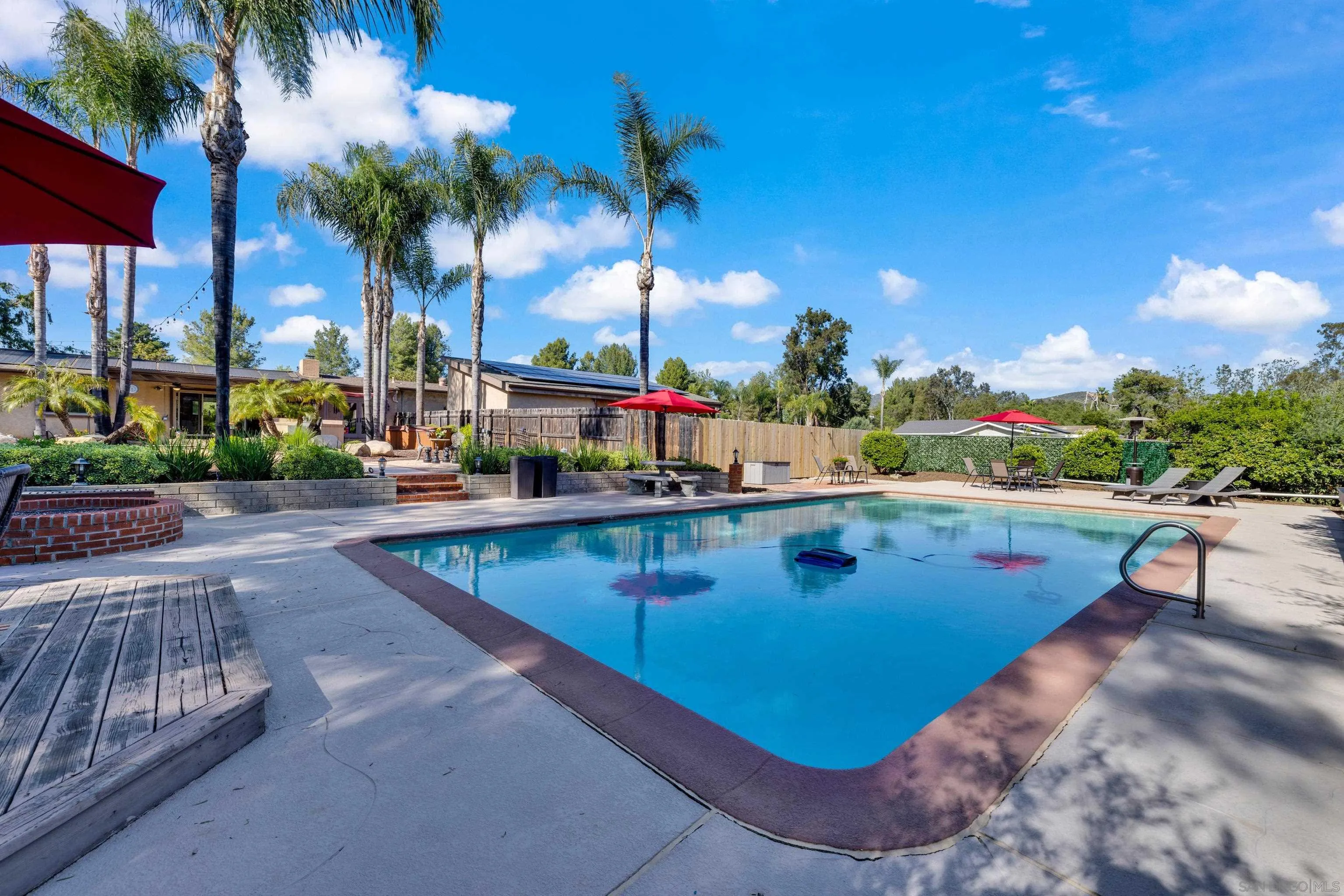 16548 Espola Road Poway, CA 92064 - Photo 52 of 70 a view of a swimming pool with a patio and a yard