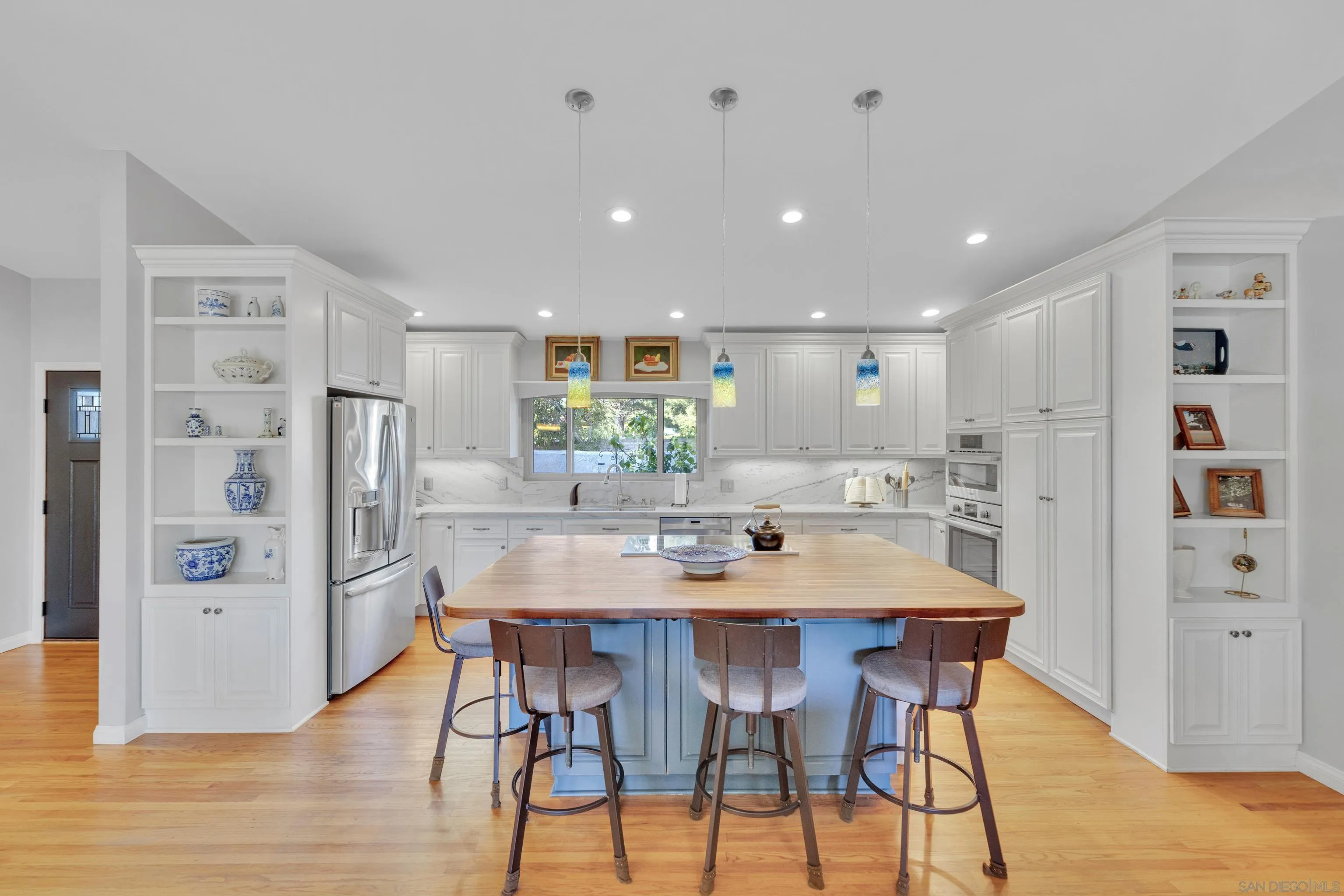 16548 Espola Road Poway, CA 92064 - Photo 8 of 70 a kitchen with stainless steel appliances kitchen island granite countertop a refrigerator and a dining table