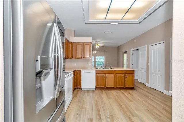 a view of a kitchen with a sink and refrigerator