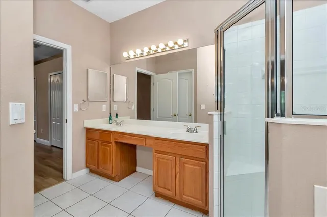 a large bathroom with a double vanity sink and a mirror
