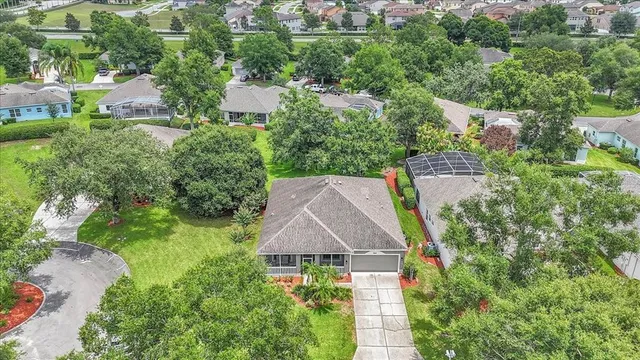 an aerial view of house with yard and swimming pool