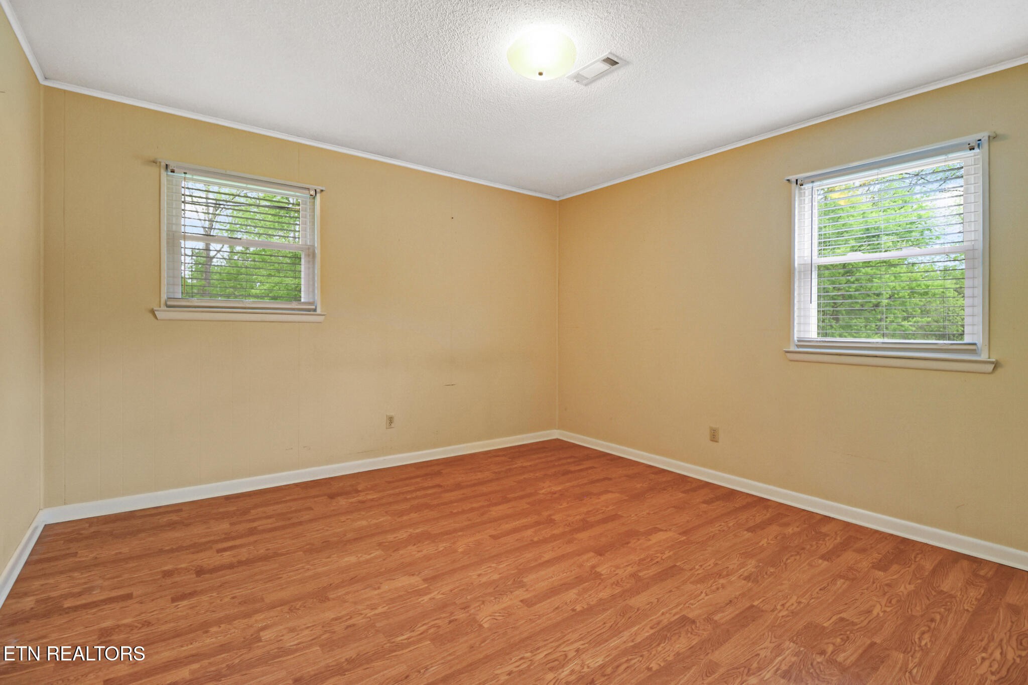 148 Porter Lane Spring City, TN 37381 - Photo 16 of 55 a view of an empty room with wooden floor and a window