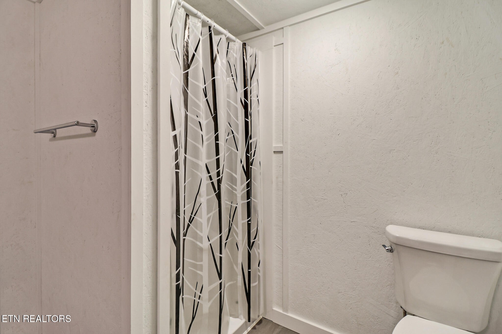 148 Porter Lane Spring City, TN 37381 - Photo 24 of 55 a bathroom with a shower curtain and a toilet