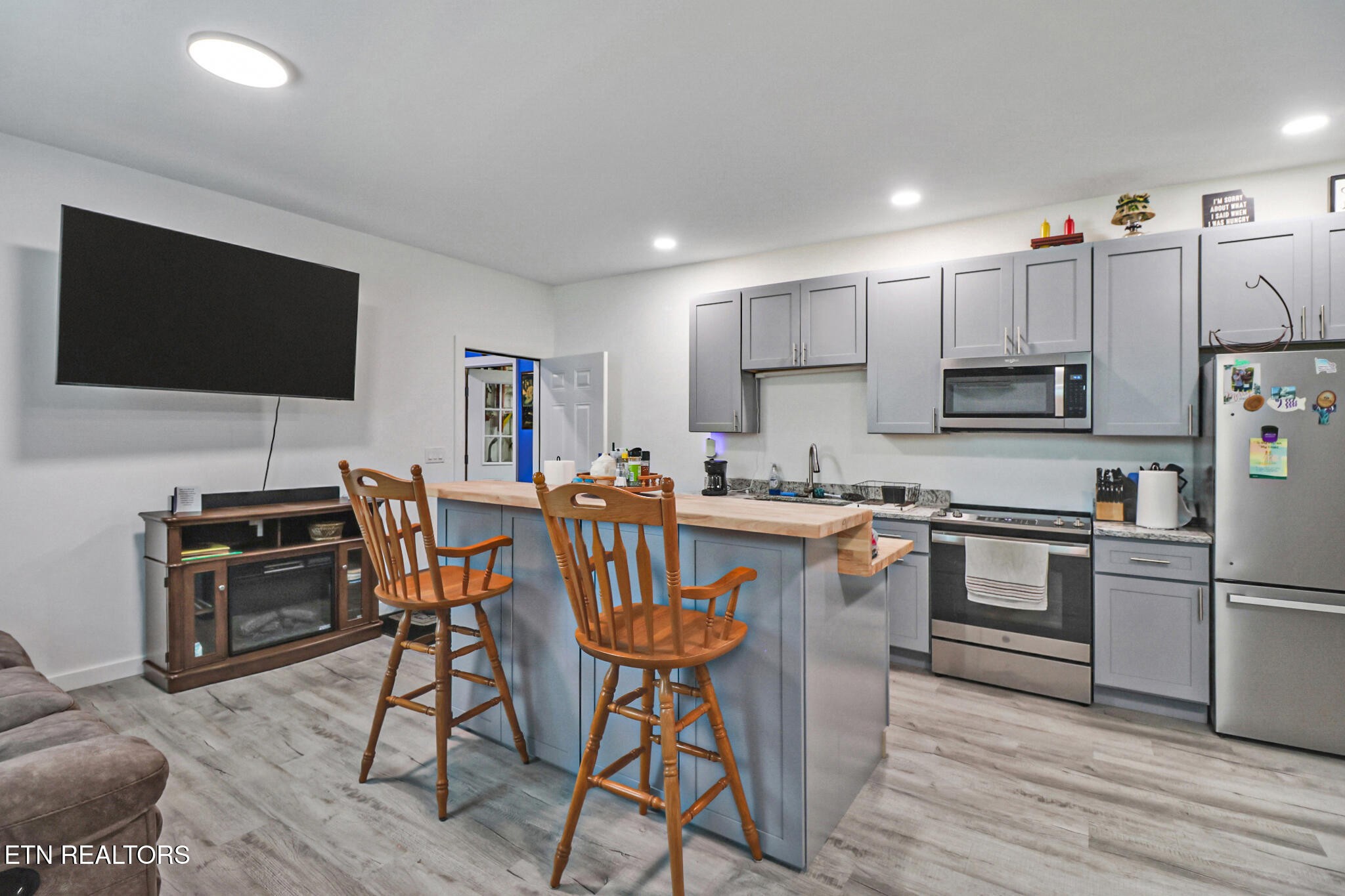 148 Porter Lane Spring City, TN 37381 - Photo 38 of 55 a kitchen with stainless steel appliances wooden floors and wooden cabinets