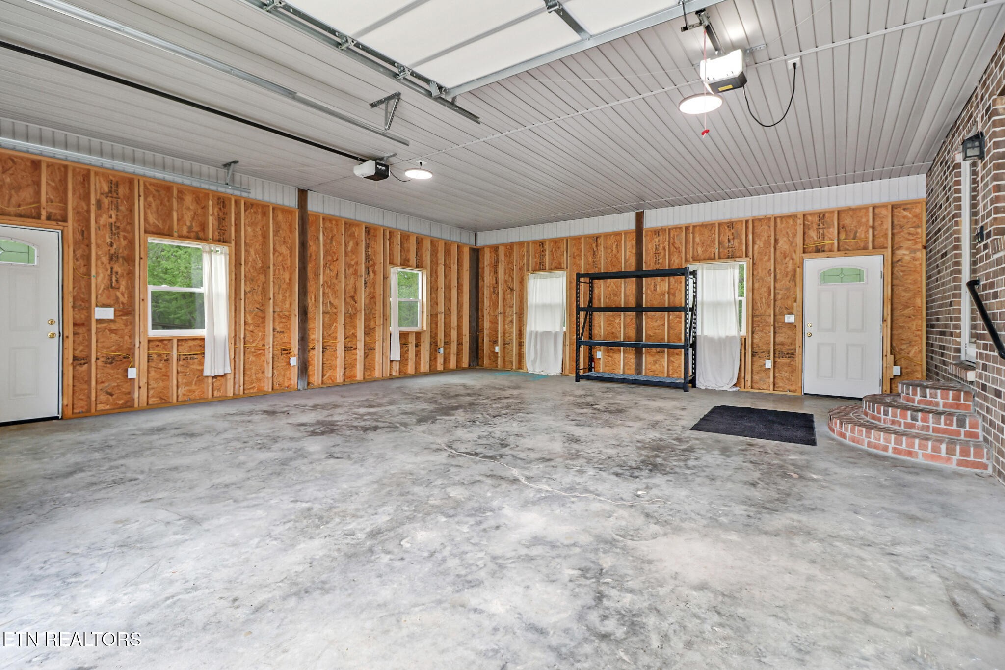 148 Porter Lane Spring City, TN 37381 - Photo 6 of 55 a view of an empty room with a window and brick walls