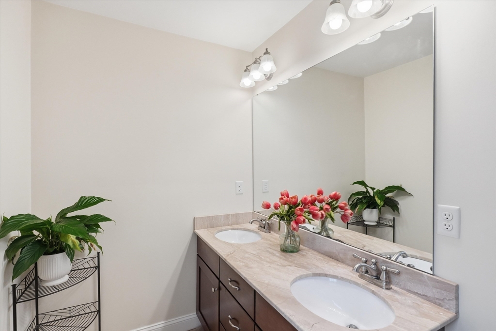 2 B Gates Lane, Unit B Wakefield, MA 01880 - Photo 18 of 42 a bathroom with a sink and a mirror