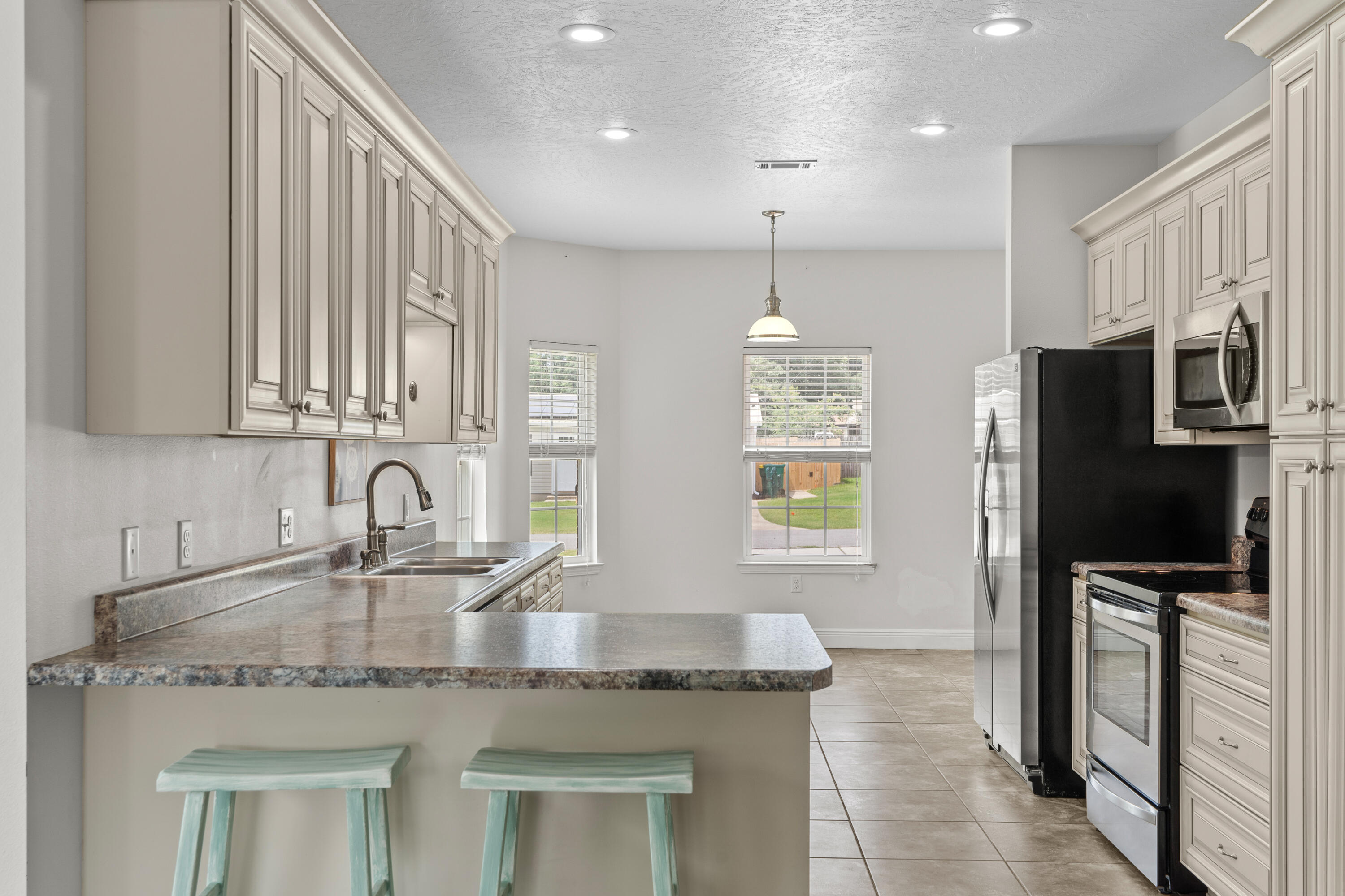 2920 Patch Avenue Crestview, FL 32539 - Photo 11 of 45 a kitchen with stainless steel appliances granite countertop a sink a refrigerator and a granite counter tops