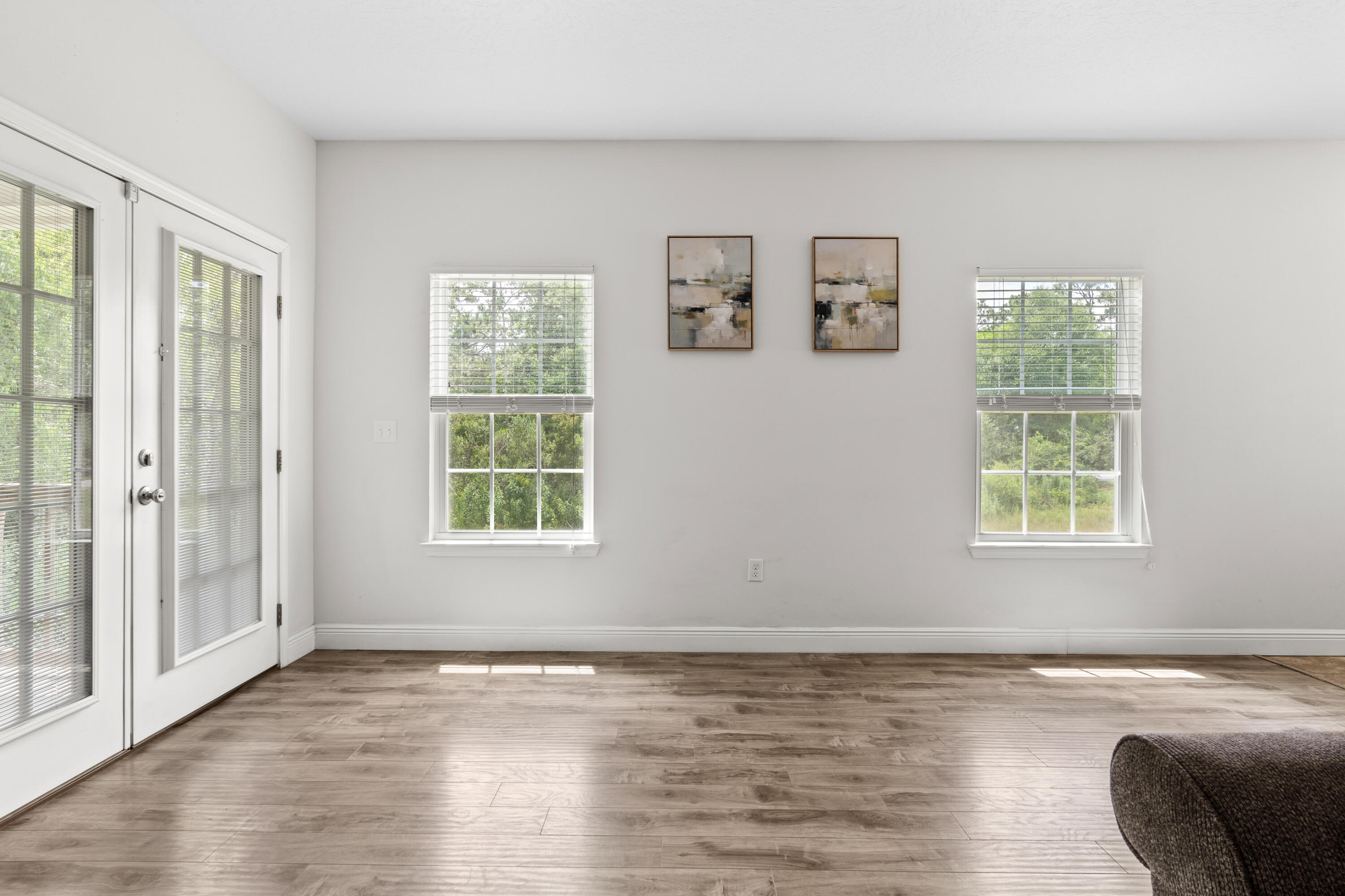 2920 Patch Avenue Crestview, FL 32539 - Photo 20 of 45 a view of an empty room with wooden floor and a window
