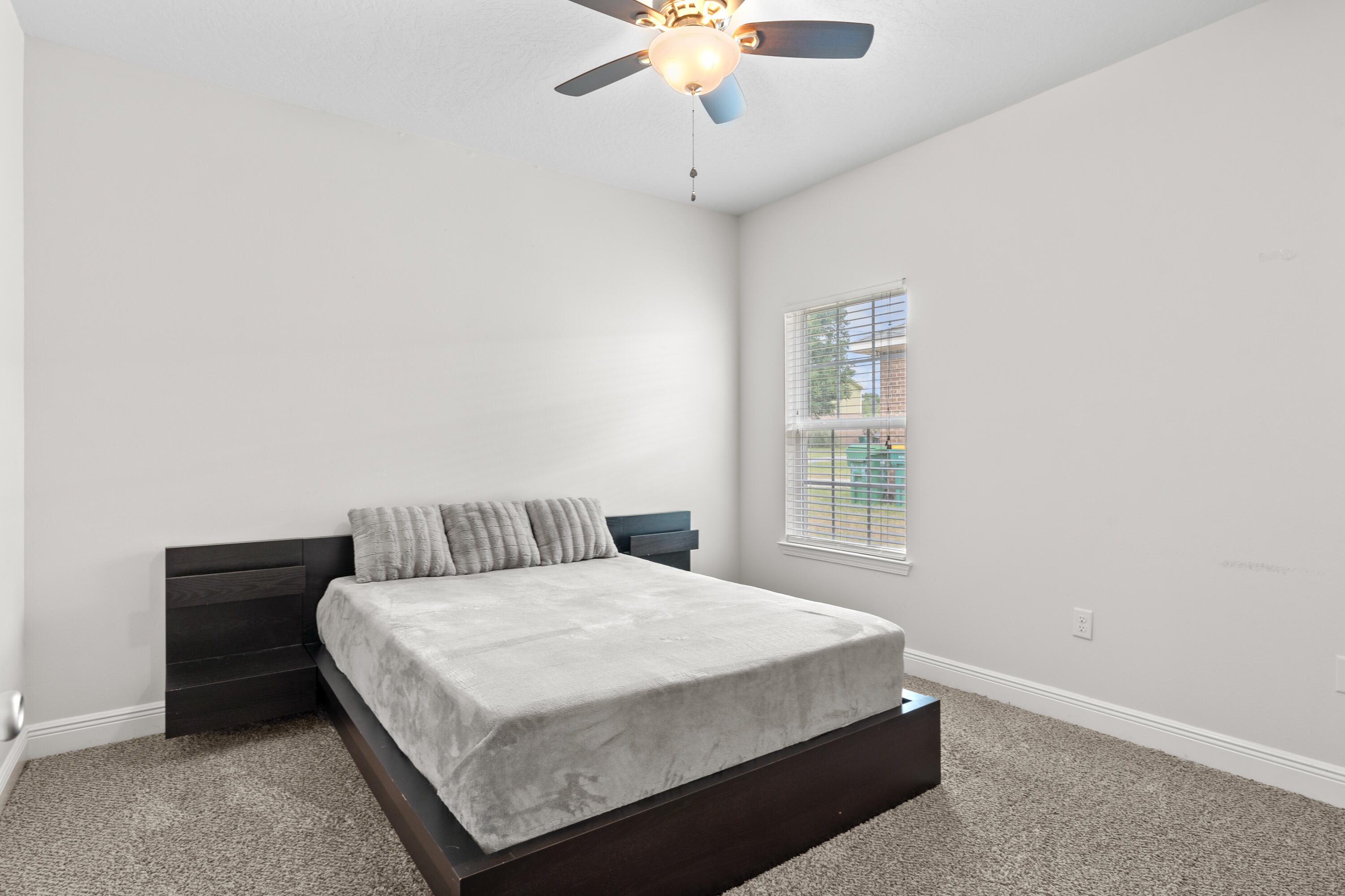 2920 Patch Avenue Crestview, FL 32539 - Photo 28 of 45 a bedroom with a bed and a chandelier