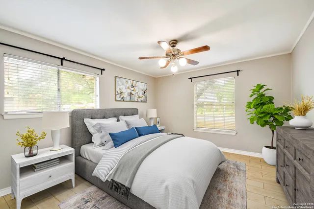 a bedroom with a large bed chandelier and a window