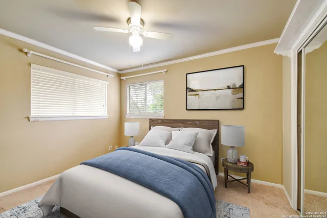 a bedroom with a bed and a painting on the wall