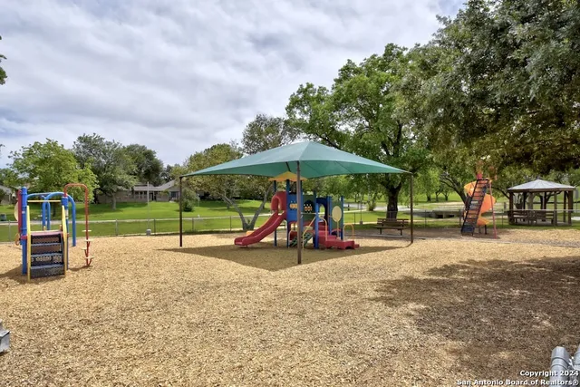 a view of outdoor space with playground and green space