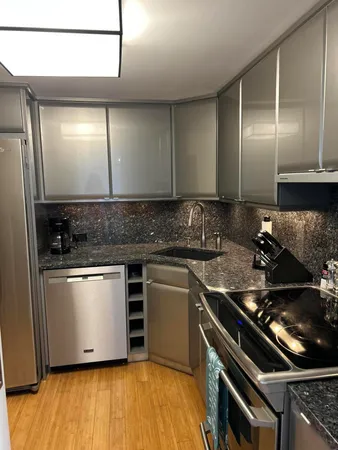 a kitchen with stainless steel appliances granite countertop a stove and a sink